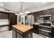 Kitchen with a center island, stainless steel appliances, and custom cabinets at 9809 W Wescott Dr, Peoria, AZ 85382