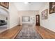Open-concept living room with hardwood floors and high ceilings at 9809 W Wescott Dr, Peoria, AZ 85382