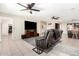 Spacious living room with tile floors, ceiling fans, and an entertainment center at 9809 W Wescott Dr, Peoria, AZ 85382