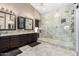 Elegant main bathroom with dual vanities, granite countertops, and a luxurious walk-in shower at 9809 W Wescott Dr, Peoria, AZ 85382