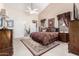 Large main bedroom with a vaulted ceiling, carpet, and access to an office at 9809 W Wescott Dr, Peoria, AZ 85382