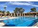 Resort-style community pool surrounded by lush landscaping and comfortable lounge area at 9809 W Wescott Dr, Peoria, AZ 85382
