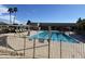 Community swimming pool featuring lap lanes, ample lounge seating, and covered patio at 9809 W Wescott Dr, Peoria, AZ 85382