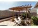 Relaxing backyard patio with a cozy pergola and seating area, perfect for outdoor entertaining at 1039 W Tuli Way, San Tan Valley, AZ 85143