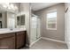 Bright bathroom features a modern glass-enclosed shower and a large window at 1039 W Tuli Way, San Tan Valley, AZ 85143