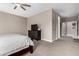 Neutral primary bedroom featuring ceiling fan, soft carpet and dark wood furniture at 1039 W Tuli Way, San Tan Valley, AZ 85143