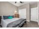 Bright bedroom featuring closet and adjacent room access door and neutral wall colors at 1039 W Tuli Way, San Tan Valley, AZ 85143