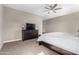 Relaxing bedroom featuring soft carpet, ceiling fan, and dark wood furniture at 1039 W Tuli Way, San Tan Valley, AZ 85143