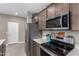 This modern kitchen boasts stainless steel appliances and white countertops paired with wooden cabinets at 1039 W Tuli Way, San Tan Valley, AZ 85143