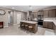 Spacious kitchen features a center island, stainless appliances and light wood-look tile flooring at 1039 W Tuli Way, San Tan Valley, AZ 85143