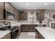 Stylish kitchen showcasing stainless appliances, white countertops, and rich wood cabinetry at 1039 W Tuli Way, San Tan Valley, AZ 85143