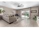 Bright living room with tile floors, neutral walls, a ceiling fan, and backyard views at 1039 W Tuli Way, San Tan Valley, AZ 85143