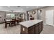 Open-concept living space connects dining area with a neutral color palette and lots of natural light at 1039 W Tuli Way, San Tan Valley, AZ 85143