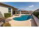 Inviting pool with a water feature, umbrella and adjacent pergola at 1039 W Tuli Way, San Tan Valley, AZ 85143