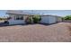 Exterior backyard view showcasing the rock yard and minimal landscaping, and a private patio at 11214 N 105Th Ave, Sun City, AZ 85351