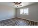 Bedroom featuring a ceiling fan, a window providing natural light, and wood-look flooring at 11214 N 105Th Ave, Sun City, AZ 85351