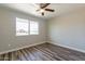 Bedroom featuring a window providing natural light, and wood-look flooring at 11214 N 105Th Ave, Sun City, AZ 85351