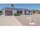 Charming single-story home with desert landscaping and solar panels on the roof at 11214 N 105Th Ave, Sun City, AZ 85351