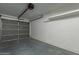 Spacious garage with concrete floor and door. Lots of potential for storage and vehicle parking at 11214 N 105Th Ave, Sun City, AZ 85351