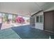 Open patio area with white roof and a view of a pink bougainvillea tree, perfect for outdoor relaxation at 11214 N 105Th Ave, Sun City, AZ 85351