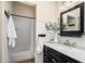 Bathroom featuring black vanity with marble countertop and bright lighting, complemented by a shower at 1126 W Elliot Rd # 1024, Chandler, AZ 85224