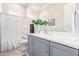 Cozy bathroom featuring a shower/tub combination and stylish vanity with grey cabinets at 11807 W Parkway Ln, Avondale, AZ 85323