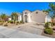 Inviting single-story home with a paved driveway, two-car garage, desert landscaping, and neutral colors at 11807 W Parkway Ln, Avondale, AZ 85323