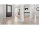 Bright foyer with wood-look tile flooring and view to Gathering room at 11807 W Parkway Ln, Avondale, AZ 85323