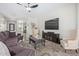 Cozy living room featuring a ceiling fan, entertainment center, and comfortable seating at 11807 W Parkway Ln, Avondale, AZ 85323