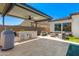 Spacious outdoor kitchen area featuring a grill, bar, seating, and modern amenities for outdoor entertaining at 11807 W Parkway Ln, Avondale, AZ 85323