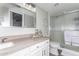 Well-lit bathroom featuring a shower and vanity with quartz countertops at 1211 N Miller Rd # 258, Scottsdale, AZ 85257