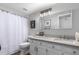 Neutral bathroom featuring a shower over tub, white vanity, modern mirror, and fixtures, providing a functional and updated space at 1211 N Miller Rd # 258, Scottsdale, AZ 85257