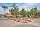 Inviting Oaksview Villas entrance with lush landscaping, palm trees and water fountain feature at 1211 N Miller Rd # 258, Scottsdale, AZ 85257