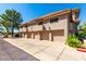 Exterior elevation showcasing multiple garages with red tile roofs, and stucco walls at 1211 N Miller Rd # 258, Scottsdale, AZ 85257