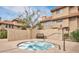 Community hot tub surrounded by stucco walls, providing a private and relaxing experience in the common area at 1211 N Miller Rd # 258, Scottsdale, AZ 85257