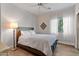 Simple bedroom with a full-sized bed, wood floors, and sheer curtains on the window at 122 W Raven Dr, Chandler, AZ 85286