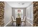 Bright breakfast nook with stone accent wall, offering a cozy spot for morning meals at 122 W Raven Dr, Chandler, AZ 85286