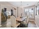 Cozy dining room featuring a rustic table, decorative chandelier, and lots of natural light at 122 W Raven Dr, Chandler, AZ 85286