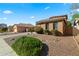 Well maintained home with desert landscaping and mature bushes on a sunny day at 122 W Raven Dr, Chandler, AZ 85286