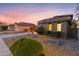 Well maintained home with desert landscaping and mature bushes on a sunny day at 122 W Raven Dr, Chandler, AZ 85286