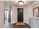 Welcoming foyer with tile flooring, decorative cabinet, and elegant front door at 122 W Raven Dr, Chandler, AZ 85286