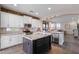 Well-designed kitchen featuring white cabinets, stainless steel appliances, and a dark kitchen island at 122 W Raven Dr, Chandler, AZ 85286