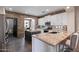 Spacious kitchen with granite countertops, stainless steel appliances, and stone accent wall at 122 W Raven Dr, Chandler, AZ 85286