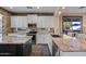 Modern kitchen with white cabinets, stainless steel appliances, and granite countertops at 122 W Raven Dr, Chandler, AZ 85286