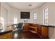 Home office with built-in wood desk, rolling chair, and views of the surrounding mountains at 122 W Raven Dr, Chandler, AZ 85286