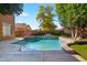 Beautiful backyard pool featuring stone waterfall features and artificial turf at 122 W Raven Dr, Chandler, AZ 85286