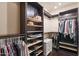 Organized walk-in closet with shelves, hanging rods, and a small white dresser at 122 W Raven Dr, Chandler, AZ 85286