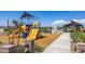 Community playground featuring a slide, sunshade, and an open-air picnic pavilion at 12547 W Parkway Ln, Avondale, AZ 85323