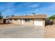 Home exterior showcasing gravel landscaped front yard, concrete driveway, and single car garage at 12608 W Lower Buckeye Rd, Avondale, AZ 85323