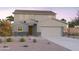 Charming two-story home featuring a two-car garage, stone accents, and drought-tolerant landscaping at 12642 W Parkway Ln, Avondale, AZ 85323